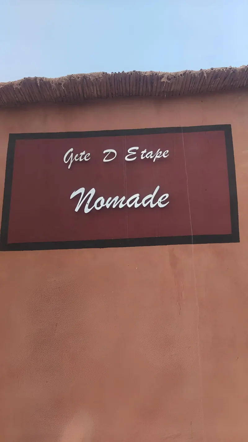 The painted sign on the wall, which reads “Gîte D Etape Nomade”
