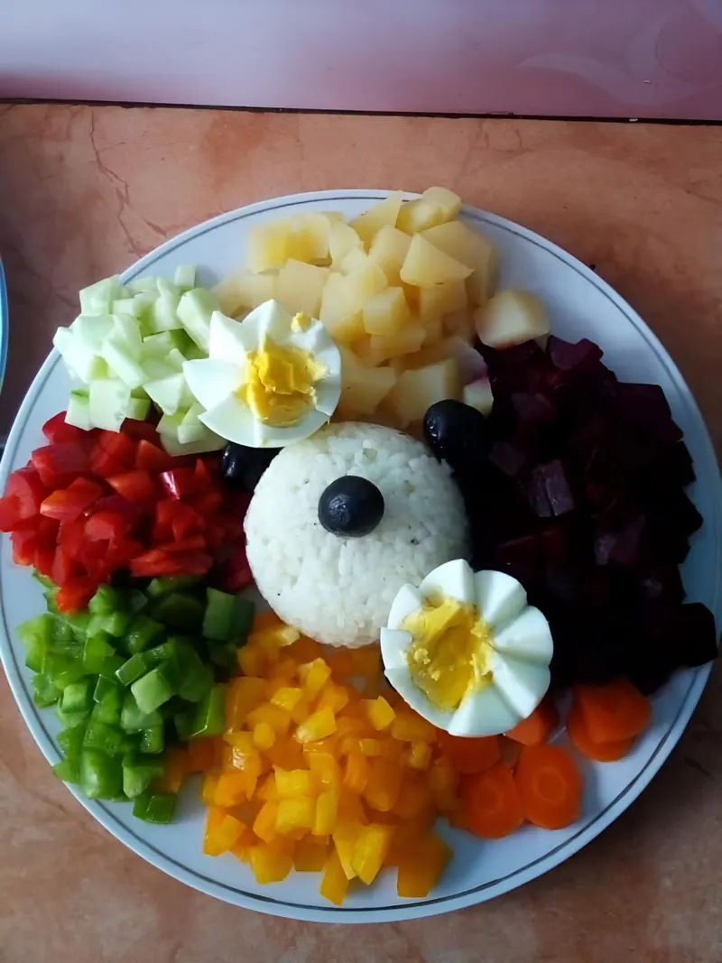 A salad plate with eggs, beetroot, peppers and olives